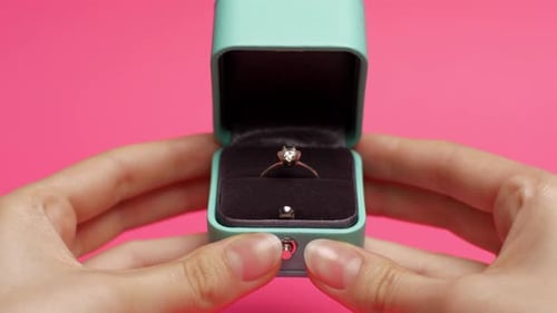 Diamond Ring in Light Green Box Being Opened