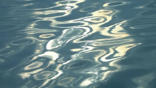 Golden Sunlight Reflecting on Rippling Blue Ocean