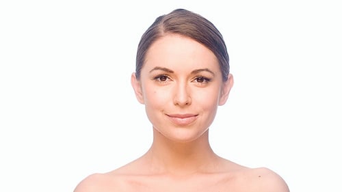 Woman Smiling and Posing Against White Background