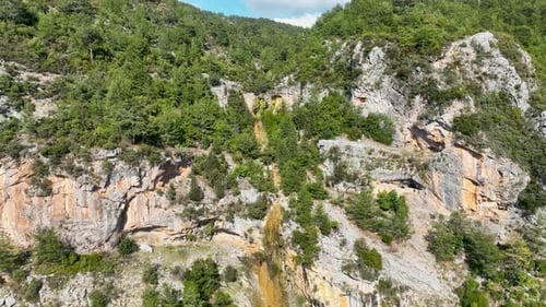 A small waterfall in the mountains aerial view 4 K
