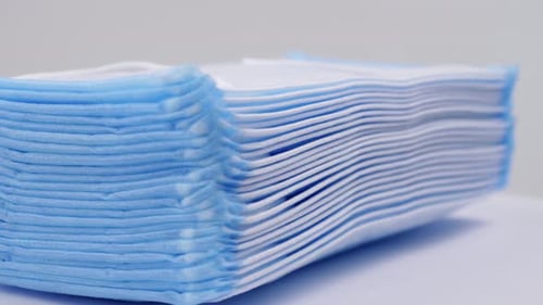 Medical blue masks slowly rotating and prevention concepts for coronavirus and viral disease.