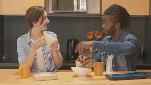 Couple Enjoying Breakfast Toast Together in Kitchen