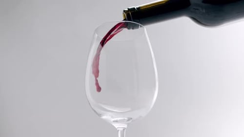 Pouring Dark Red Wine into Glass