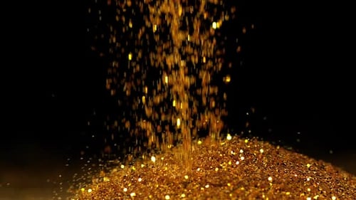 Gold Powder falling against Black Background, Slow motion