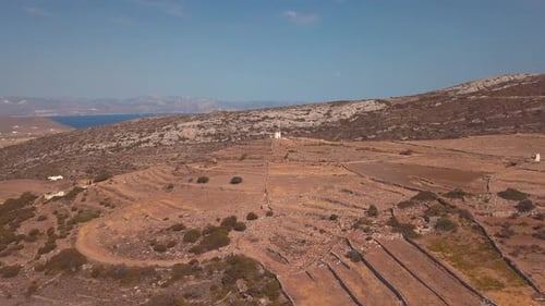 Aerial Drone Shot Punching in Revealing a Single Building Atop a Hill on the Island of Lekes Greece
