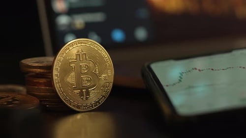 Bitcoin Leaning Against Stack of Coins Close Up