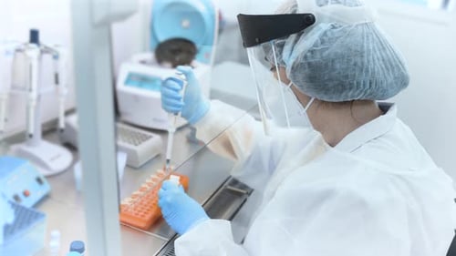 Scientist Using Pipette in Bright Laboratory Setting