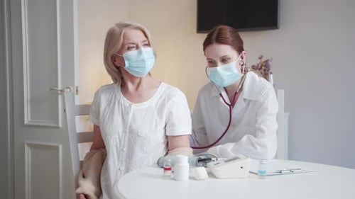 Doctor Examines Senior Patient with Stethoscope