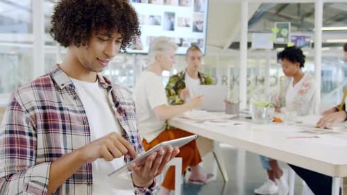 Male creative using smartphone in a modern office