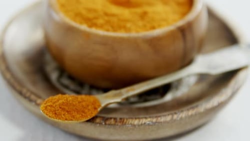 Turmeric powder in plate 4k