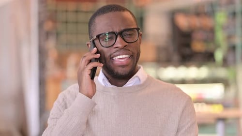 Young Man Talking on Phone Close Up