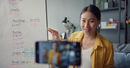 Enthusiastic Woman Teaching Physics Online in her Home