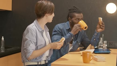 Friends Eating and Talking at Kitchen Table