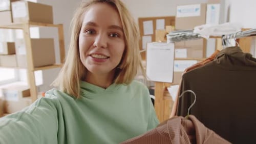 Woman Presenting Fashion Clothing in Home Office