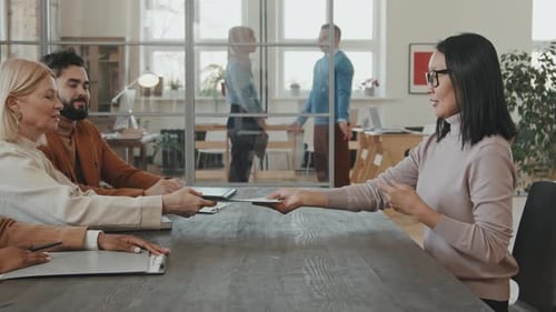 Asian Woman at Board Job Interview in Office