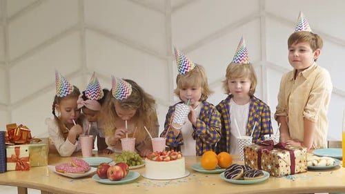 Children Celebrating Birthday Party with Treats and Gifts