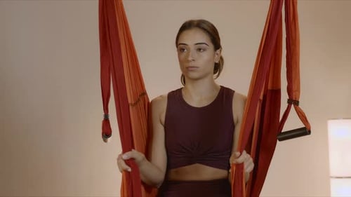 Woman Sitting in Hammock at Yoga Studio. Girl Hanging in Hammock for Fly Yoga