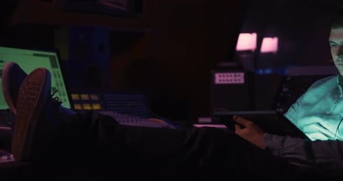 Male sound engineer using digital tablet