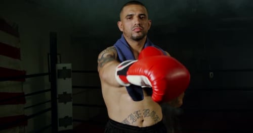 Man Bounces in Boxing Ring Shadowboxing