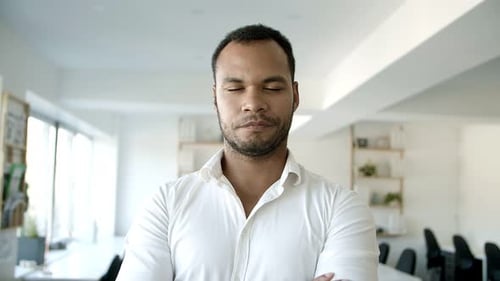 Young Bearded Guy Standing with Crossed Arms at Office.