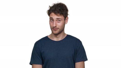 Smiling Young Adult Winks and Makes Finger Gun