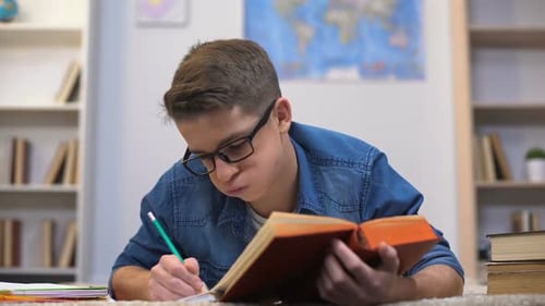 Teen Student Lying Down Studying at Home