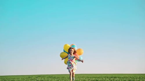 Girl Running with Balloons in a Sunny Field