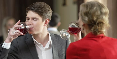 Young Man and Older Woman Drinking Wine Together