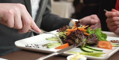 People Having Lunch Together with Salad and Wine