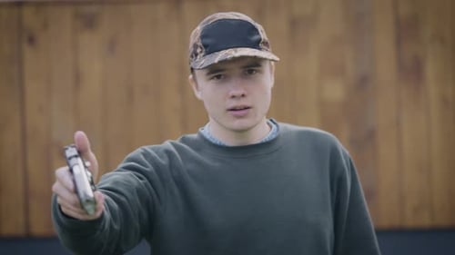 Young Man Yelling Holding a Pistol