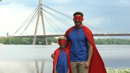 Father and Son Superheroes by River Give Thumbs Up