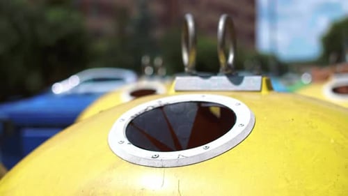 Recycling Plastic Cup in Yellow Urban Bin