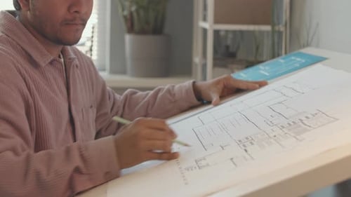 Young Adult Architect at a Desk Working on Design