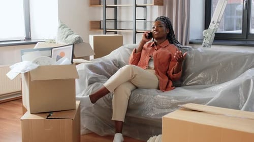 Happy Woman Calling on Phone Moving to New Home