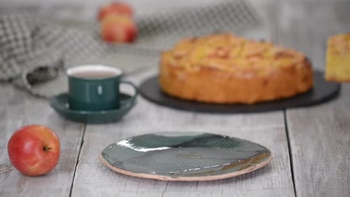 Serving Slice of Apple Cake with Tea and Peaches