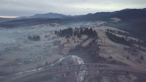 Flight Over the Village and Railway Bridge in the Carpathian Mountains