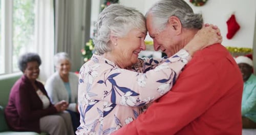 Elderly Couple Dancing Tenderly During Christmas Celebration