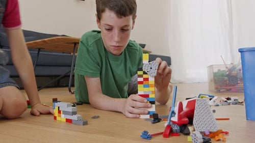 Children Building Colorful Plastic Blocks Together