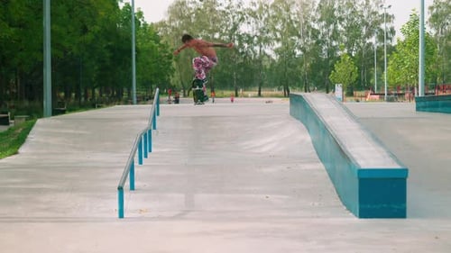 Shirtless Man Skateboarding at Park in Daytime