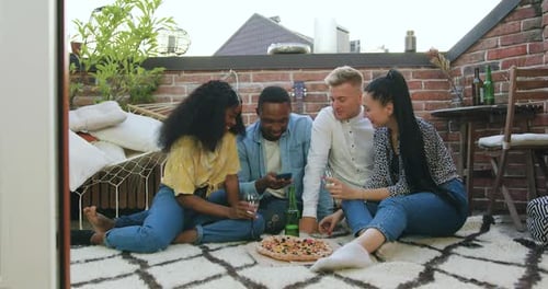 Friends Enjoying Pizza on Urban Rooftop