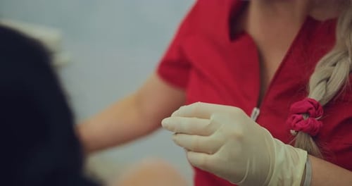 Health Worker Prepares Medical Tool in Clinic