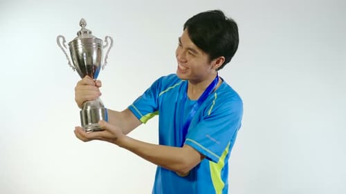Man Kiss Trophy And Celebrating
