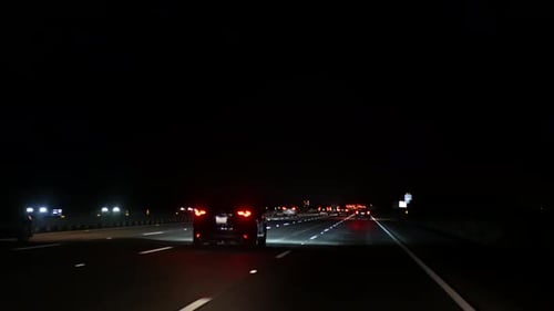 View From the Car. Los Angeles Busy Freeway at Night Time. Massive Interstate Highway Road