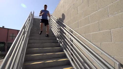Man Exercising, Running Down Stairs Outdoors
