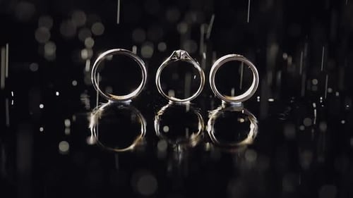 Three Wedding Rings with Water Droplets