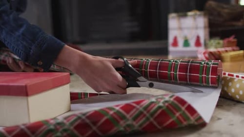 Cutting Wrapping Paper to Wrap Christmas Gifts