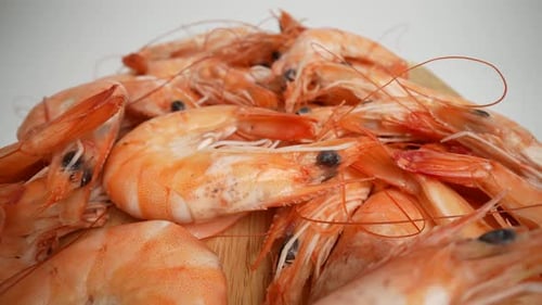 Cooked Shrimp Pile on Wooden Cutting Board