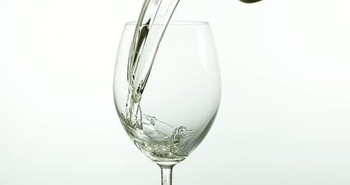 Clear Liquid Pouring into a Wine Glass