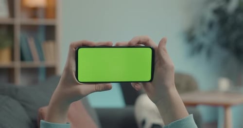Close Up of Male Hands Holding Smartphone with Green Screen