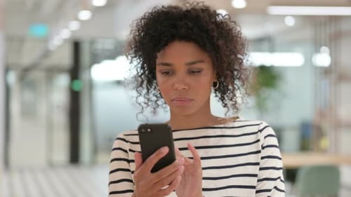 Woman Uses Mobile Device in Modern Office